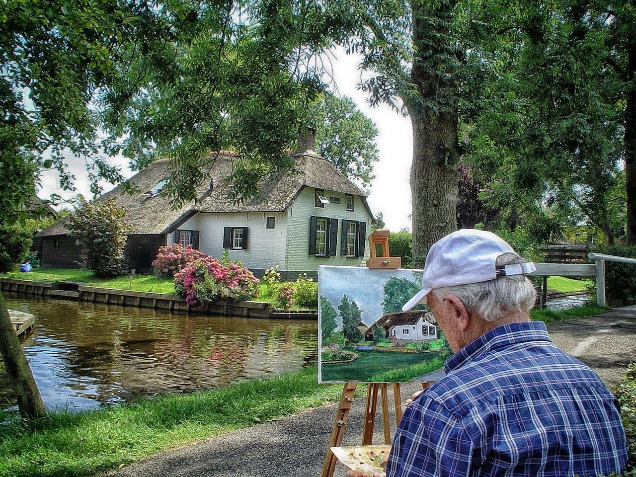 an old man painting giethoorn village